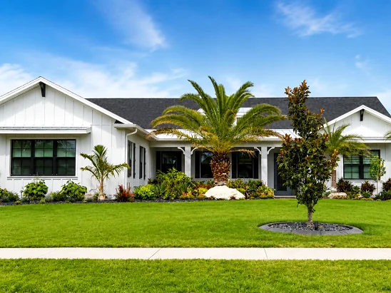 Wide lawn and new beds in front of a modern white home