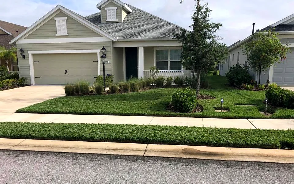 New sod front lawn and planting beds at a single-story home